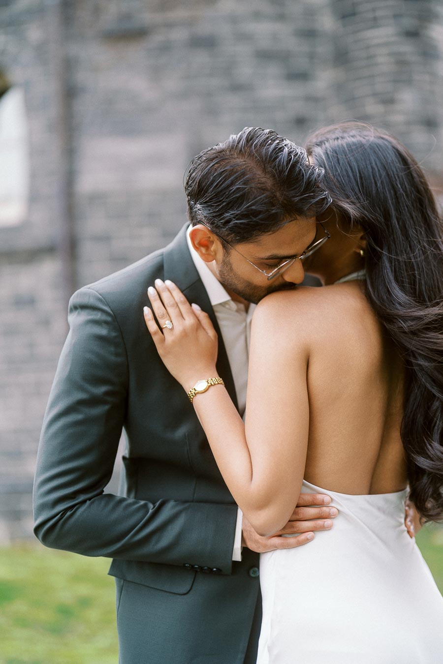 A close-up of Tej and Priyana embracing outdoors at the University of Toronto, with Priyana’s engagement ring on display.