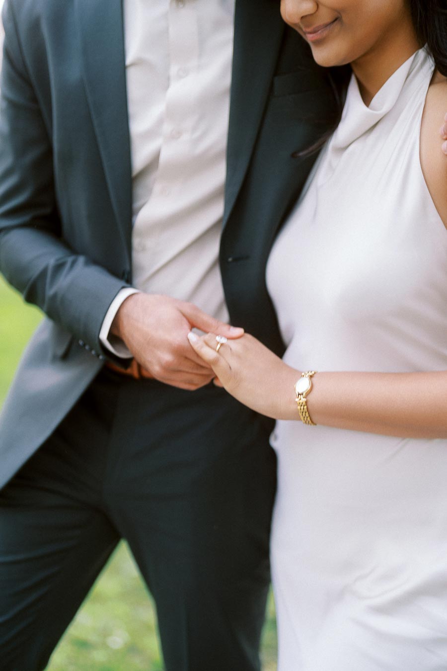 A close-up of Tej and Priyana holding hands, focusing on Priyana's engagement ring at the University of Toronto.