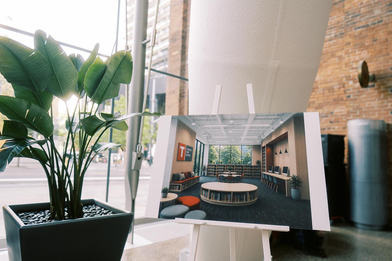 Rendering of Toronto Prep School's new elementary space on an easel beside a potted plant at Ricarda’s event venue in Toronto.