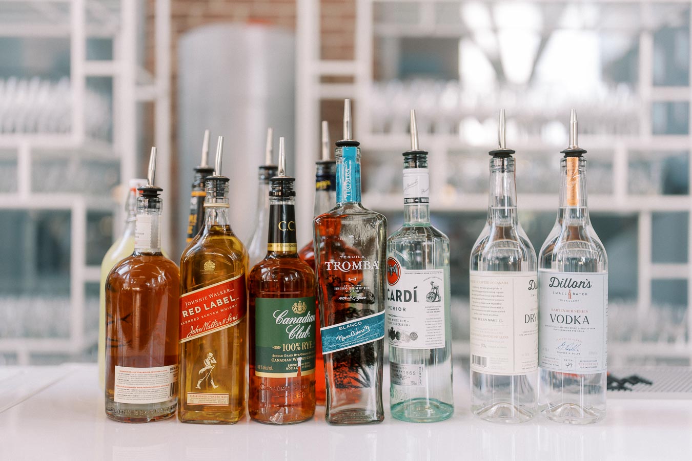 Various liquor bottles, including whisky, tequila, rum, gin, and vodka, arranged on a bar counter at Ricarda’s during the Toronto Prep Forever Launch Party.