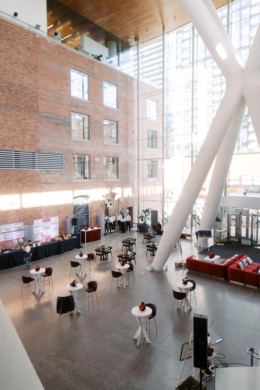 Spacious, sunlit modern atrium at Ricarda’s in Toronto, set up for the Toronto Prep Forever Launch Party with cocktail tables, lounge seating, and event staff.