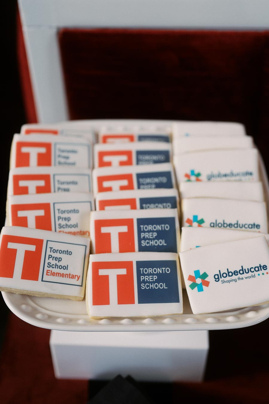 A white platter displays rectangular cookies decorated with Toronto Prep School and Globeducate logos at the Toronto Prep Forever Launch Party in Toronto.