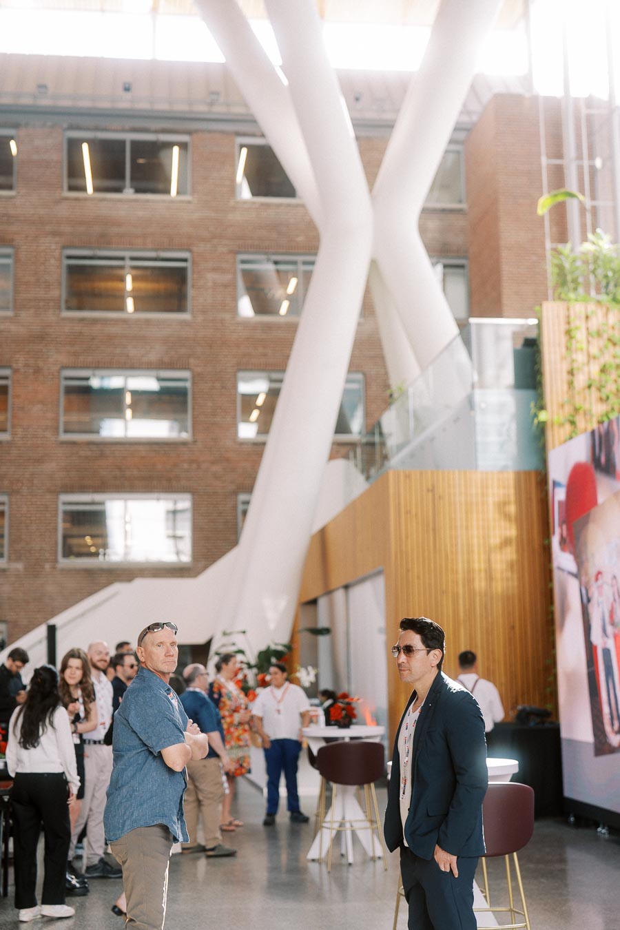 Attendees gather and converse in the modern, sunlit Atrium at Ricarda’s during the Toronto Prep Forever Launch Party in Toronto.