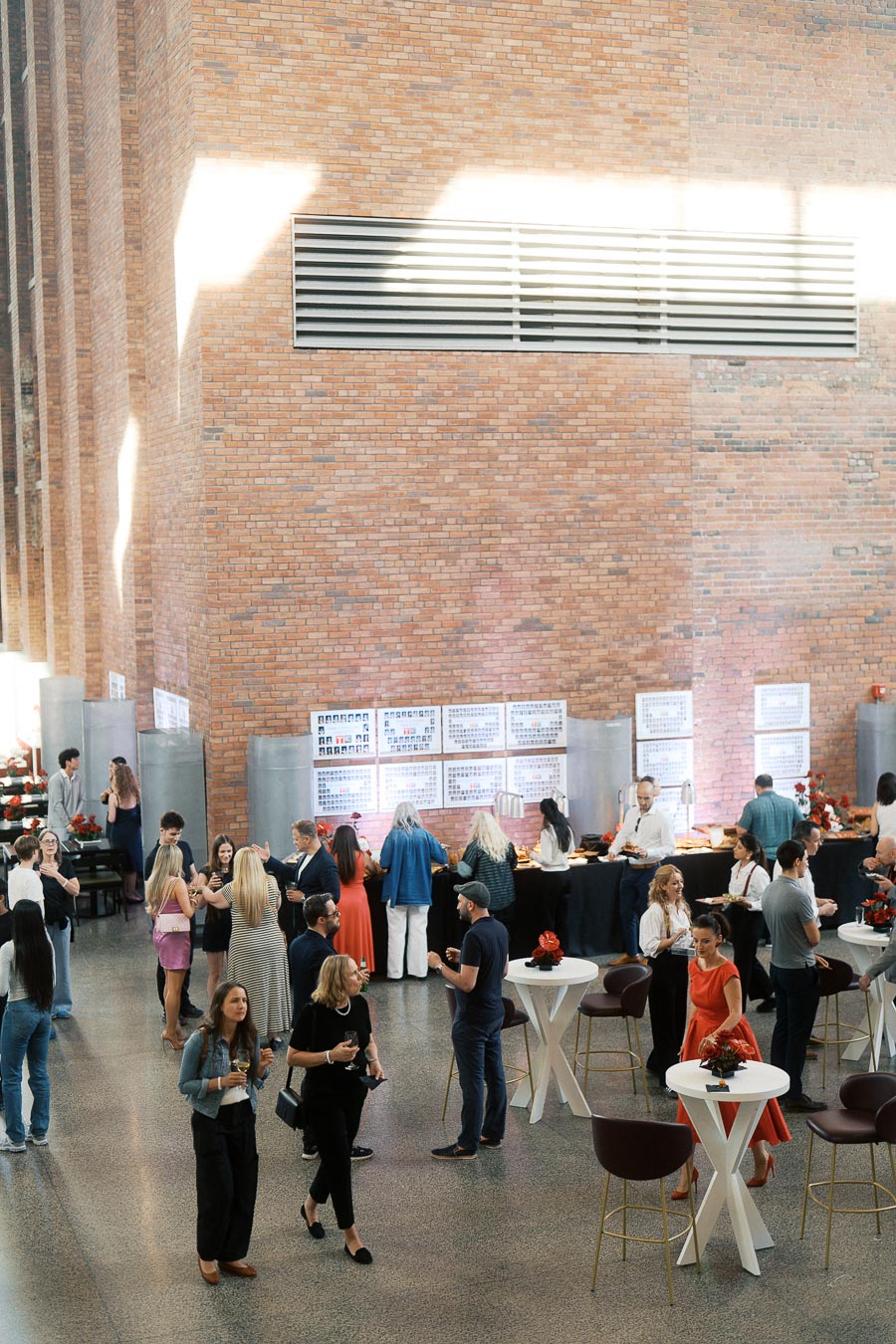 Guests gather and network in the modern brick atrium of Ricarda’s in Toronto during the Toronto Prep Forever Launch Party, with food stations and event signage visible.
