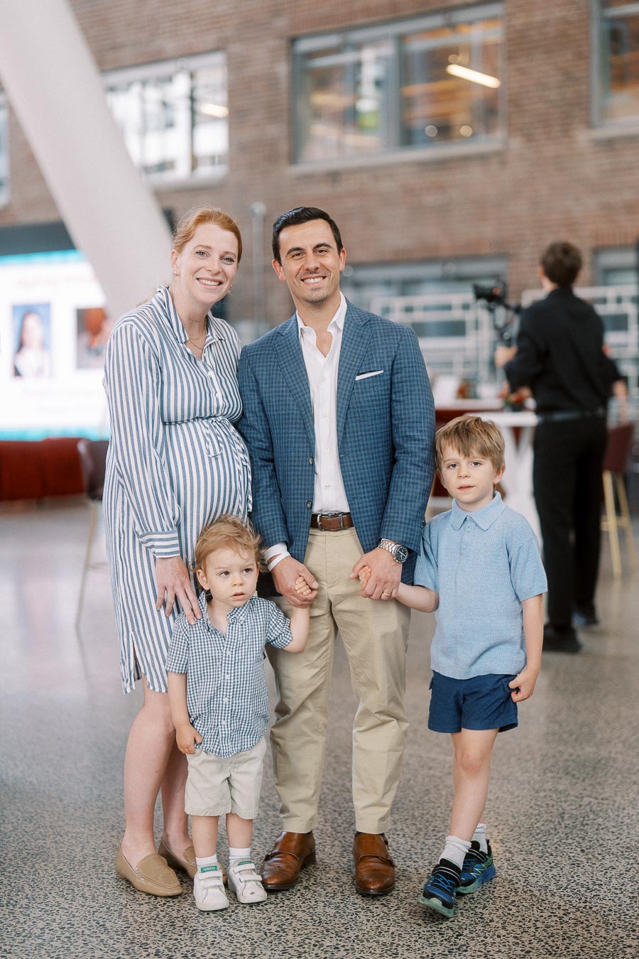A family of four, including two young children, stands smiling together at The Atrium at Ricarda’s during the Toronto Prep Forever Launch Party in Toronto.