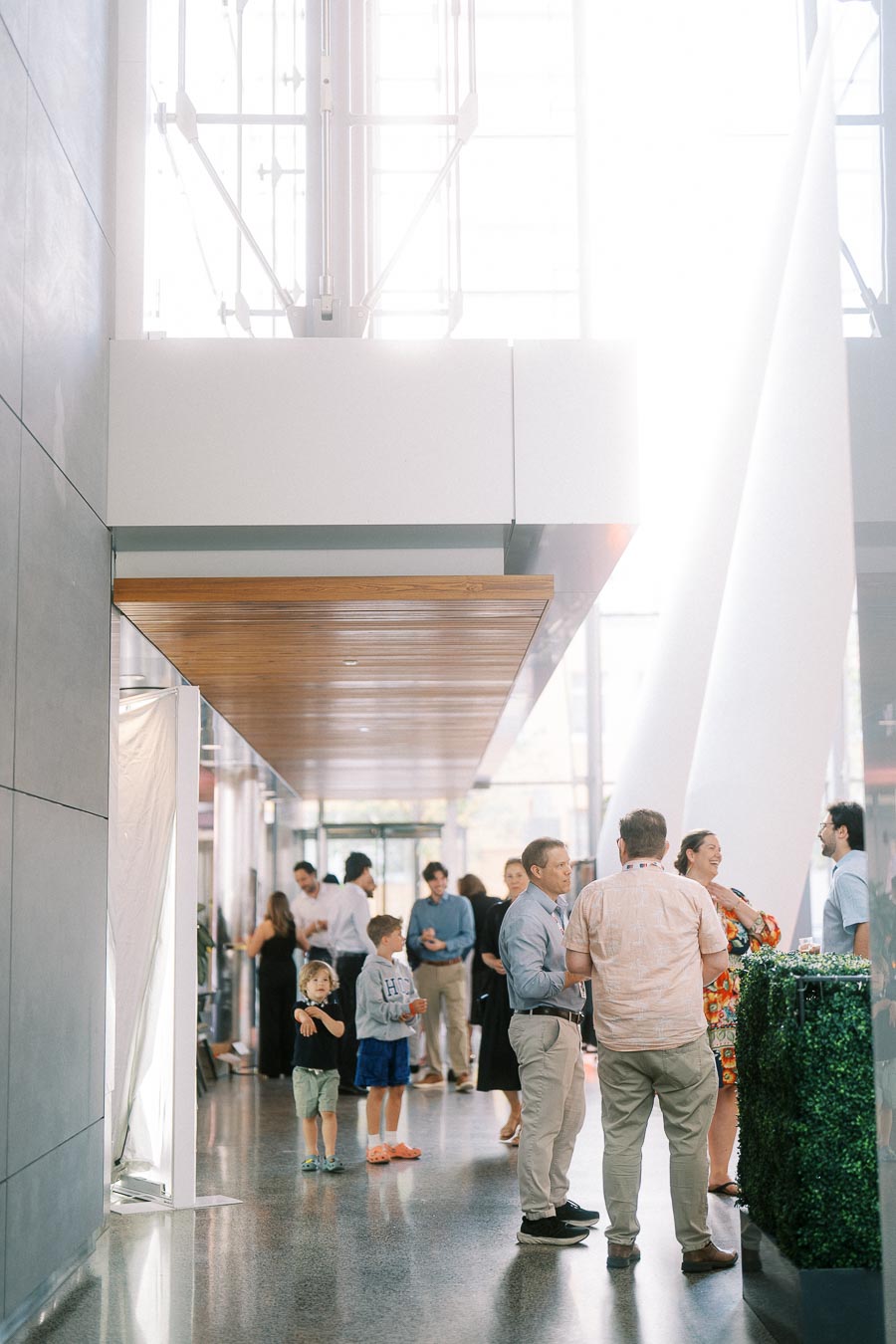 Adults and children gather and socialize in the bright, modern atrium of Ricarda’s during the Toronto Prep Forever Launch Party in Toronto.