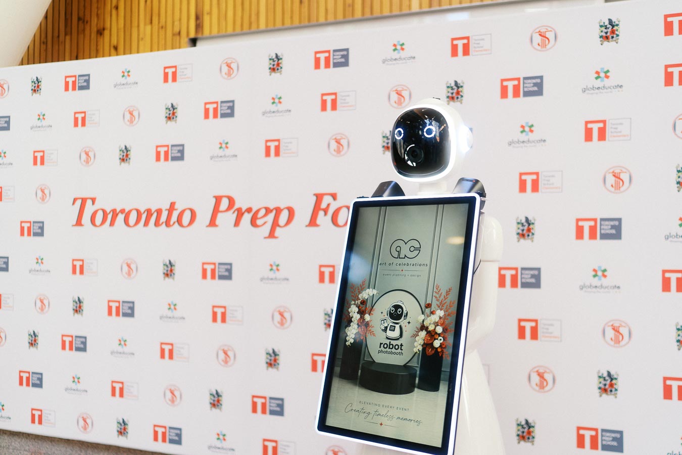 Robot photobooth positioned before a Toronto Prep School branded step-and-repeat wall at Ricarda’s event space in Toronto, Ontario.
