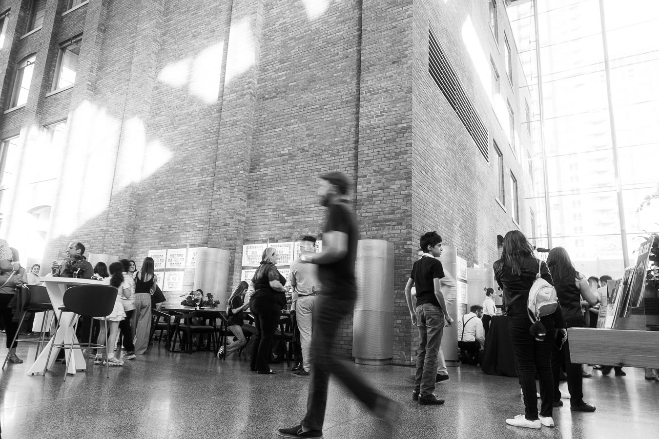 Guests of various ages gather and walk through the sunlit, modern brick atrium at Ricarda’s in Toronto during the Toronto Prep Forever Launch Party.