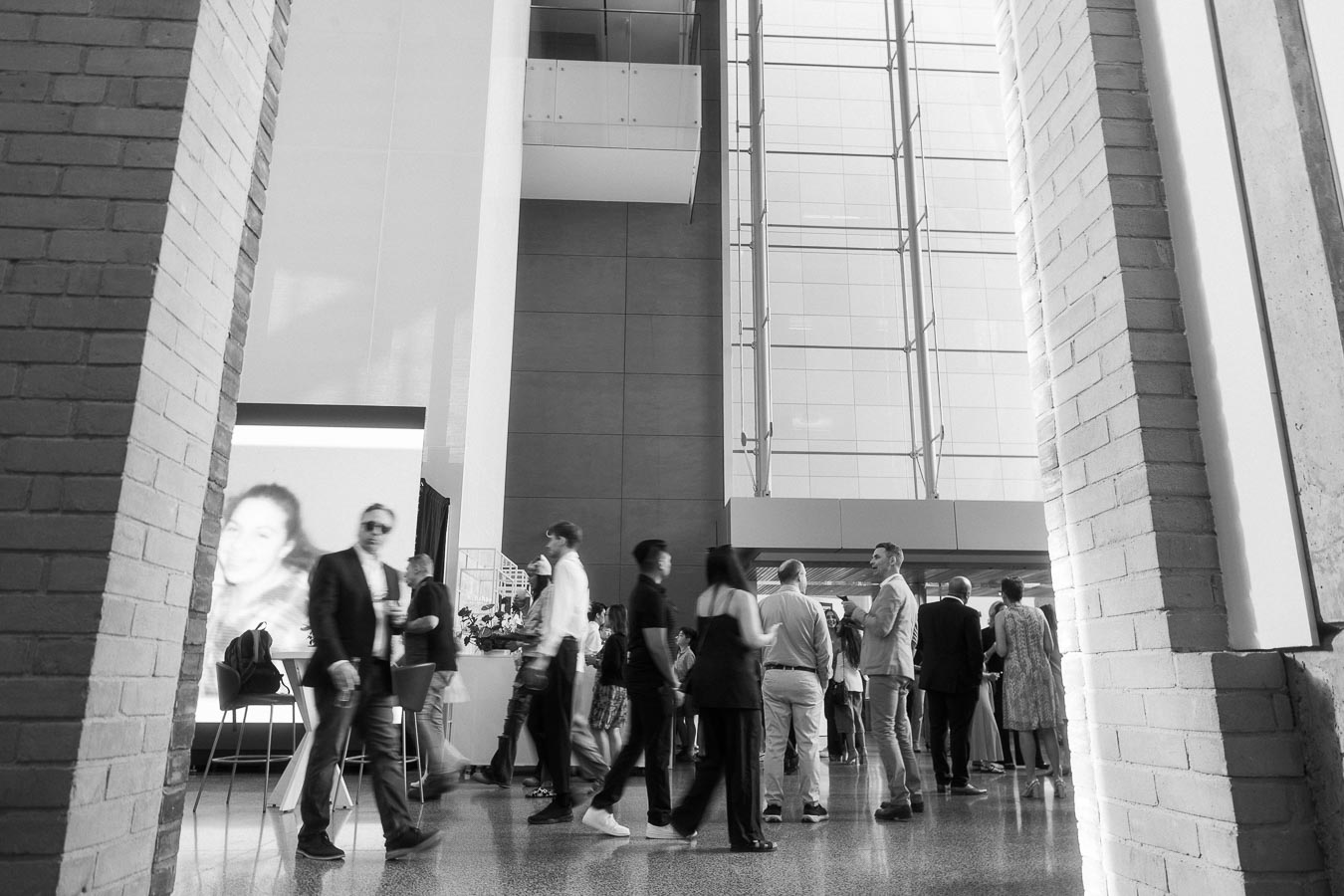 Guests socializing in the bright, modern atrium of Ricarda’s during the Toronto Prep Forever Launch Party, with high glass walls and architectural columns visible.