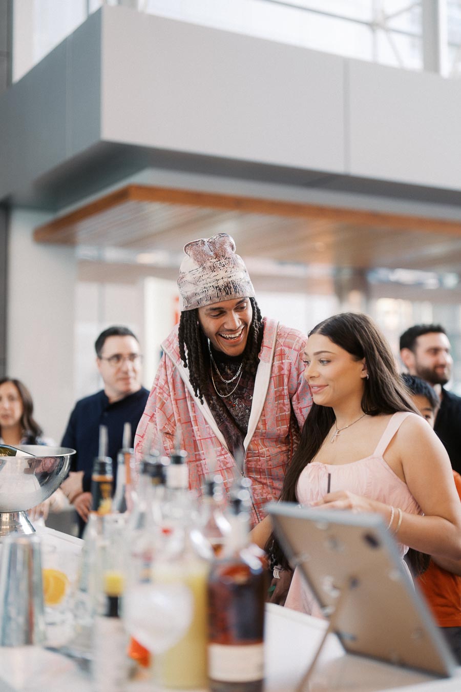 A group of guests socialize at the bar during the Toronto Prep Forever Launch Party at Ricarda’s in Toronto, with drinks and event decor visible.