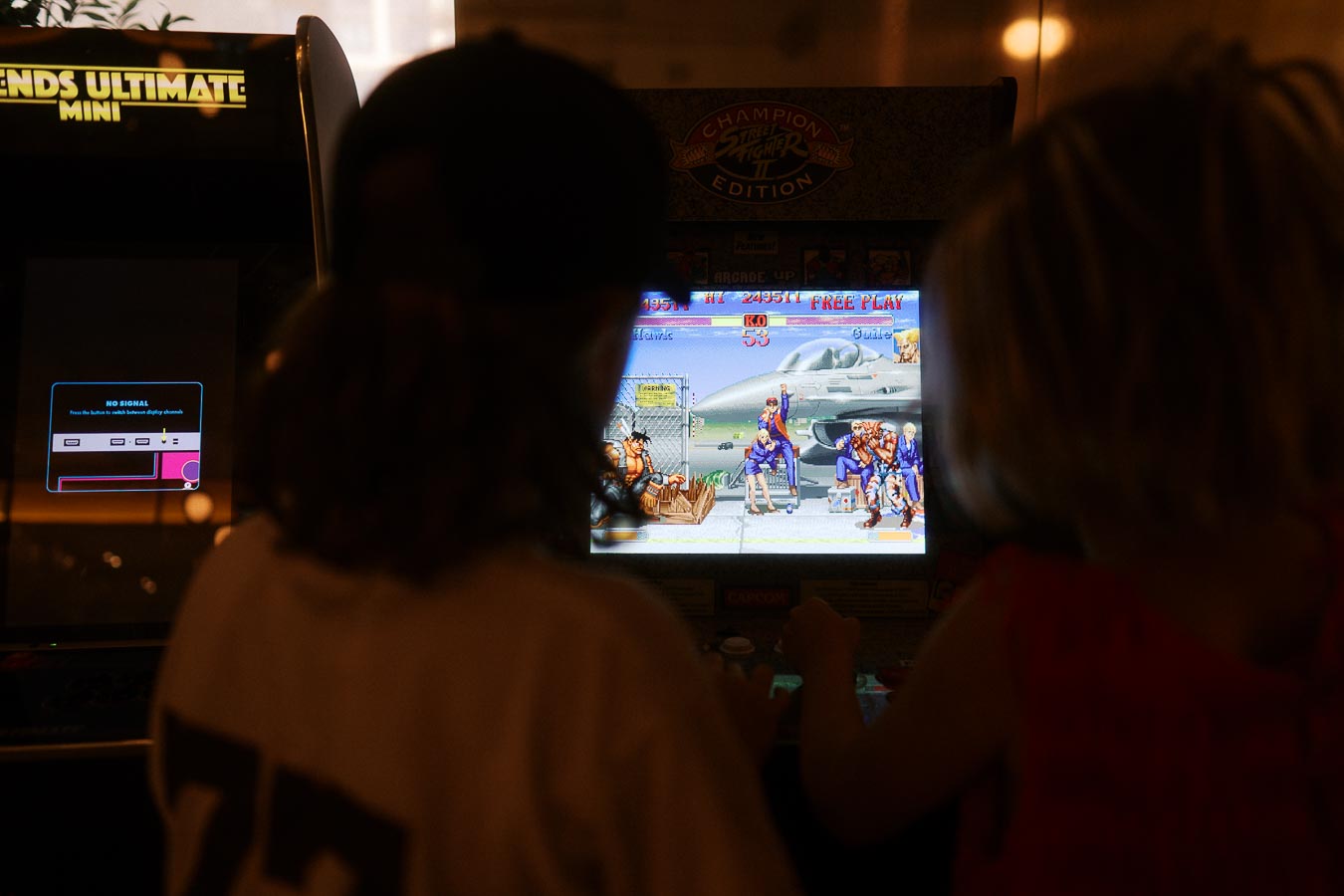 Two children seen from behind playing a classic arcade game at the Toronto Prep Forever Launch Party at Ricarda’s in Toronto.