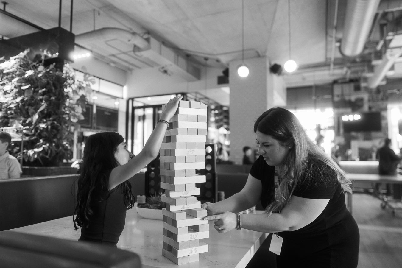 A child and an adult play a giant Jenga game at Ricarda’s during the Toronto Prep Forever Launch Party, reflecting family-friendly activities at the event.