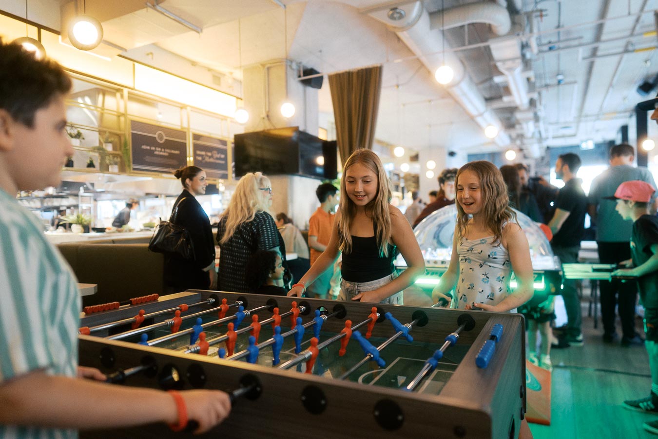 Children playing foosball in a lively kids’ lounge area during the Toronto Prep Forever Launch Party at Ricarda's Restaurant, Toronto.