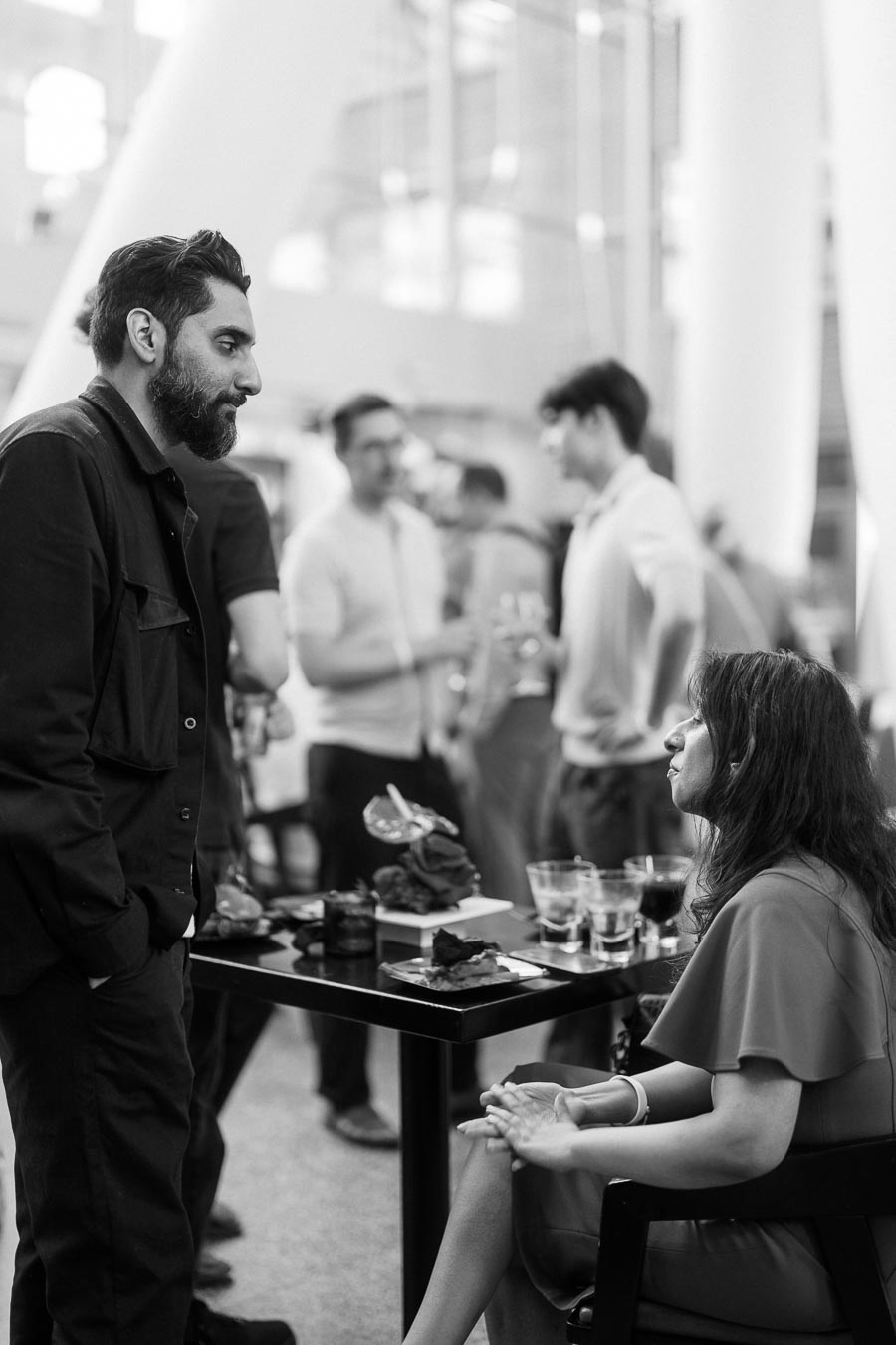 A man and woman engage in conversation at a table with food and drinks during the Toronto Prep Forever Launch Party at Ricarda's in Toronto.