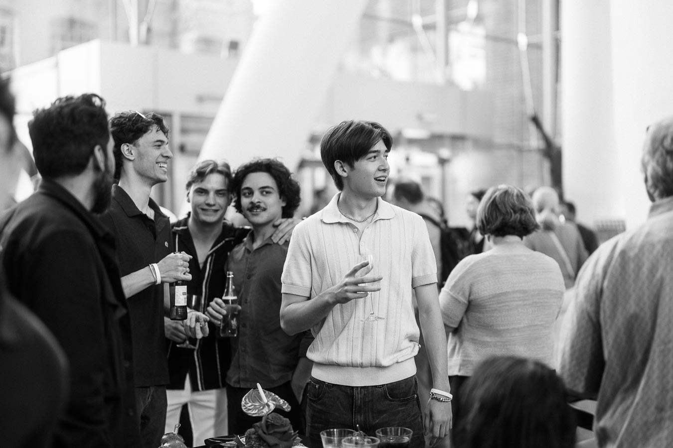 A group of young men stand together with drinks, smiling and talking at the Toronto Prep Forever Launch Party at Ricarda’s in Toronto.