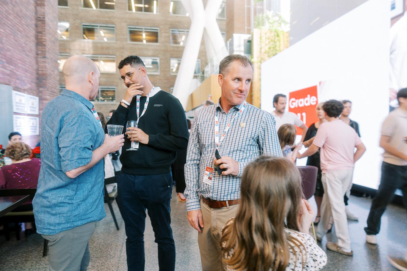 Adults and children interact at the Toronto Prep Forever Launch Party inside Ricarda's Atrium, with event signage and modern architecture visible.