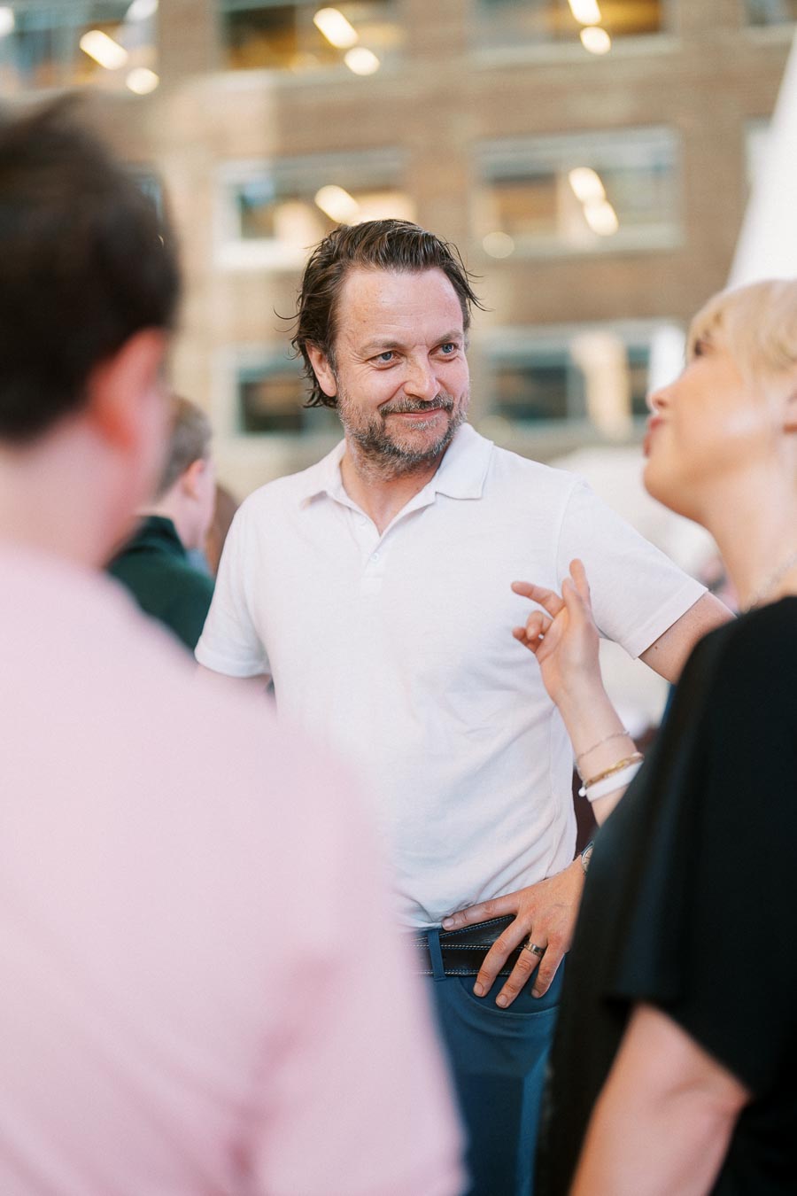 A man in a white shirt smiling and talking with other guests during the Toronto Prep Forever Launch Party at Ricarda’s Restaurant in Toronto.