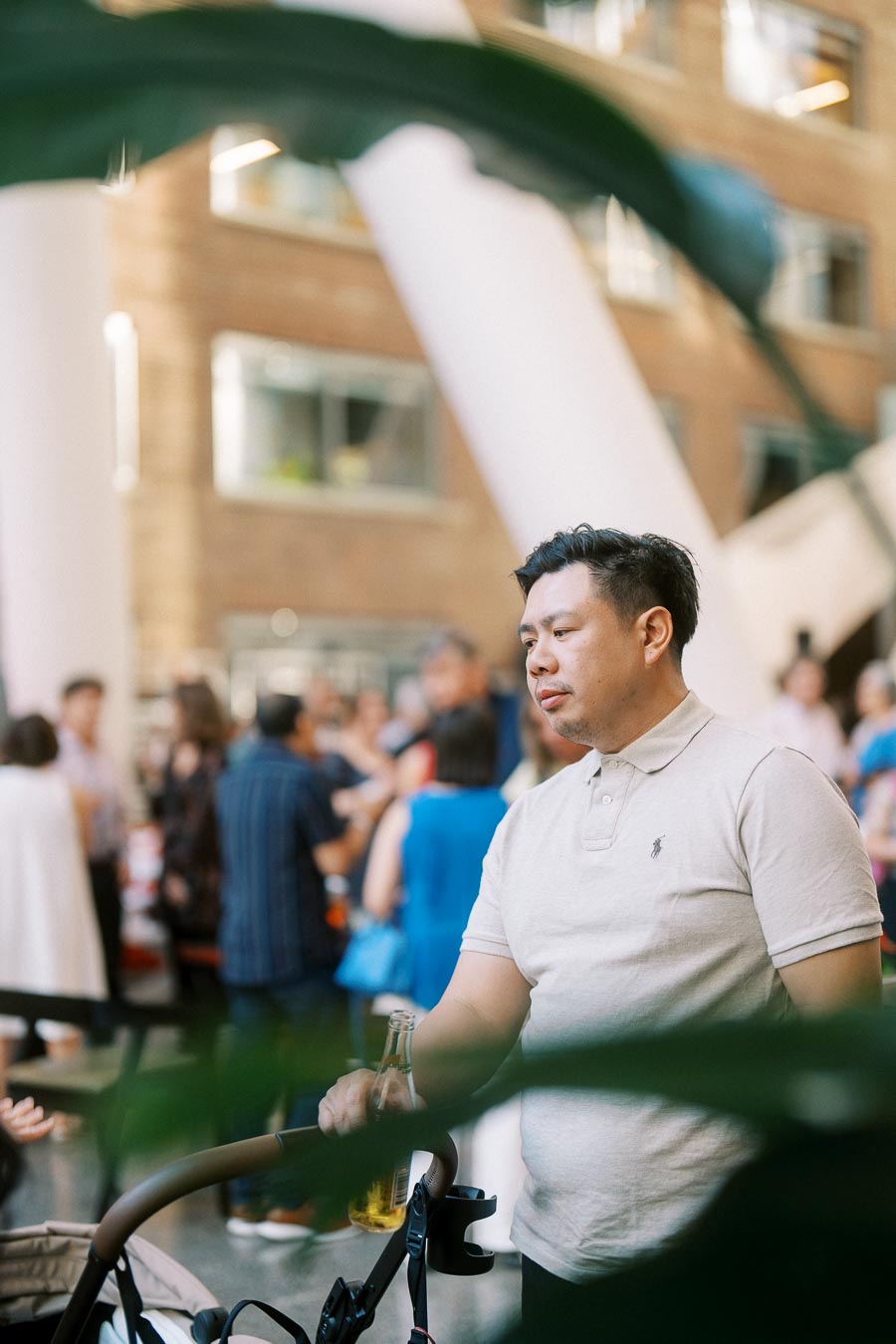 A man with a stroller and drink stands among guests at the Toronto Prep Forever Launch Party inside The Atrium at Ricarda’s, Toronto.