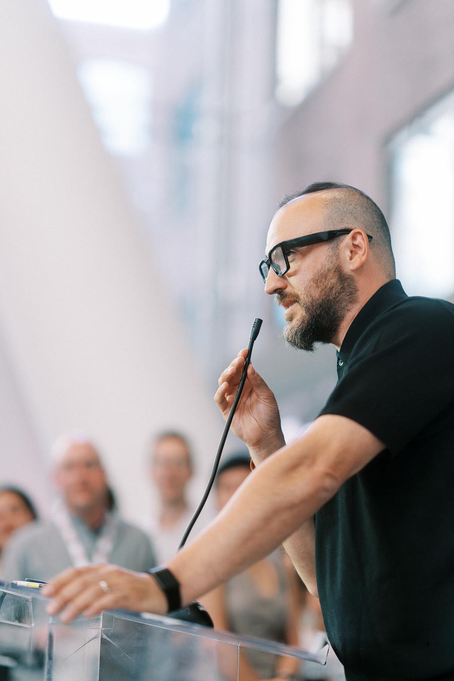 A man with glasses speaks into a microphone at a podium during the Toronto Prep Forever Launch Party at The Atrium at Ricarda’s, Toronto.