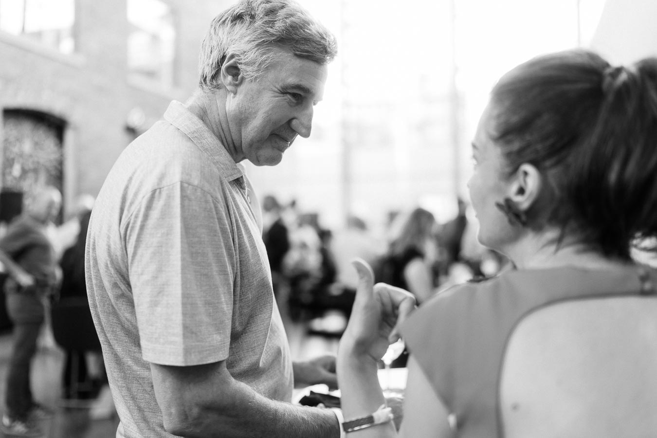 Two adults in conversation at the Toronto Prep Forever Launch Party, Ricarda’s, Toronto, with a modern event space background.