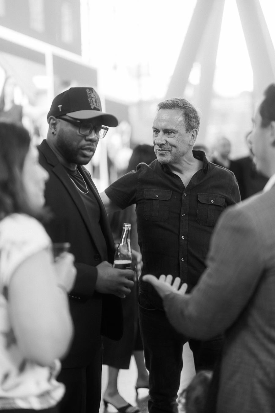 A group of adults in conversation at the Toronto Prep Forever Launch Party, with one guest holding a drink, photographed at Ricarda's in Toronto.
