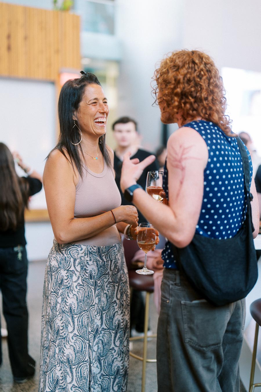Two adults enjoying a friendly conversation with drinks in hand at the Toronto Prep Forever Launch Party, Ricarda’s, Toronto.