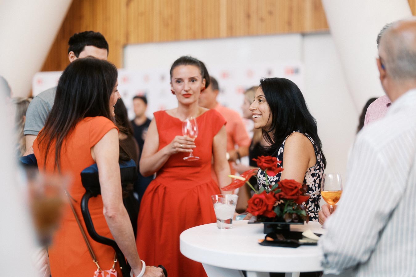 Group of guests in semi-formal attire socializing at a cocktail table with red roses during the Toronto Prep Forever Launch Party at Ricarda’s in Toronto.