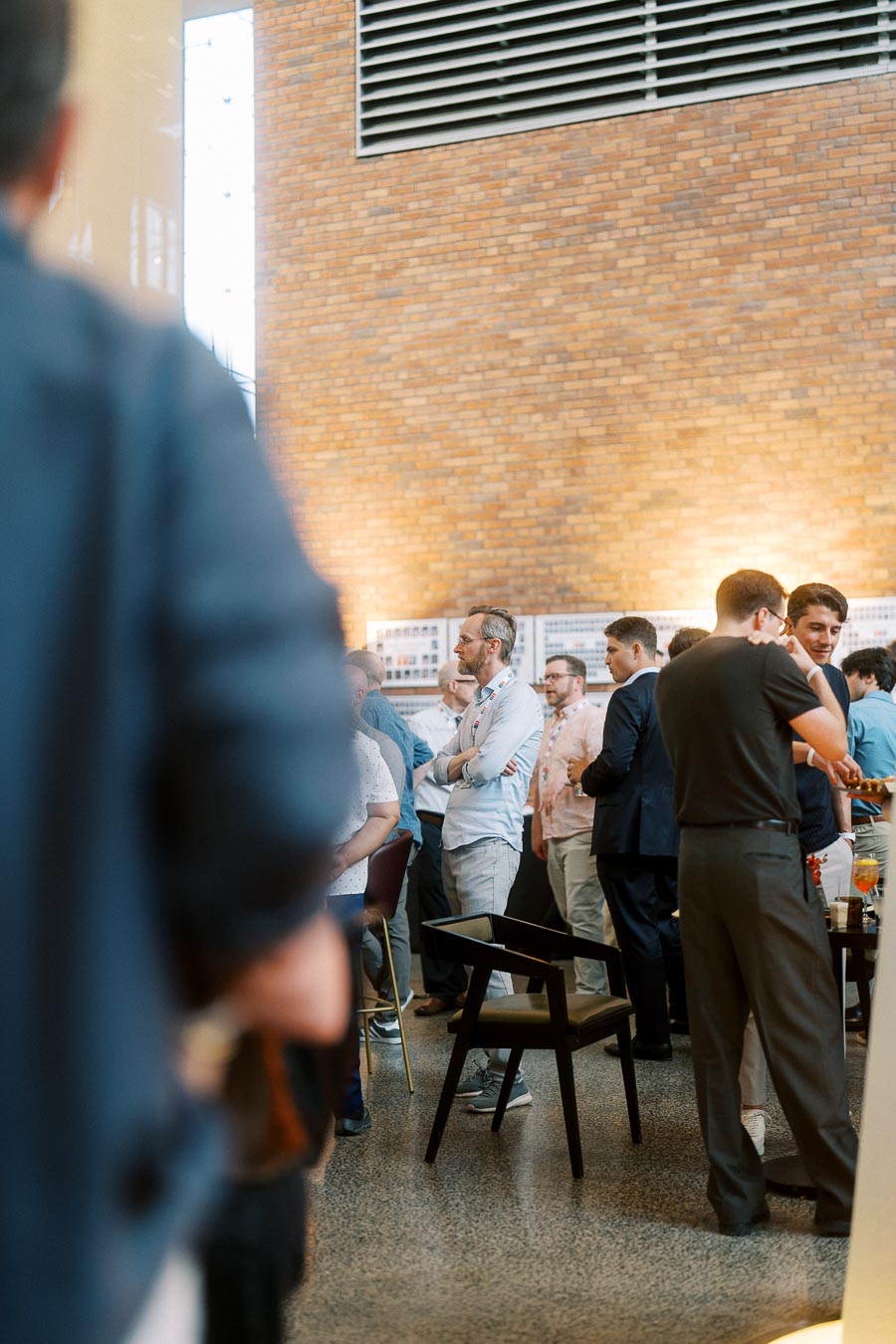 Guests mingling and networking at the Toronto Prep Forever Launch Party, held inside The Atrium at Ricarda’s with exposed brick walls and modern event space lighting.