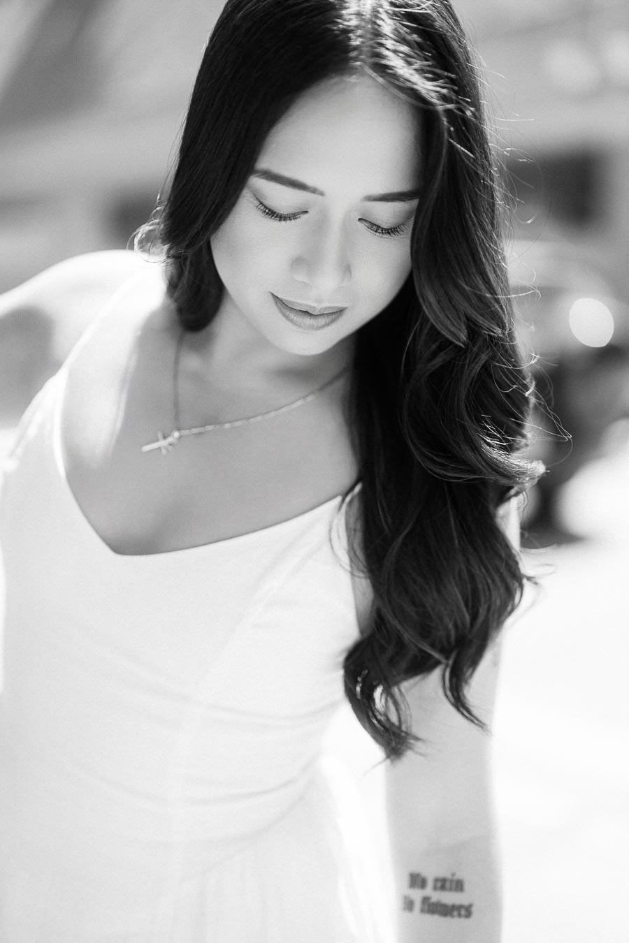Cassie looking down with a gentle expression, captured in close-up during her engagement session in downtown Toronto.