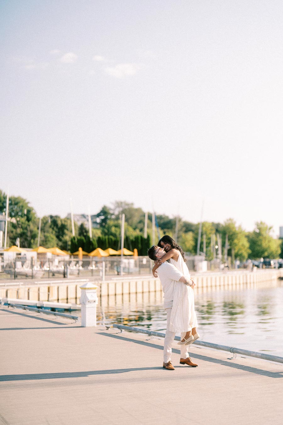 Amber and Devin embrace on a marina dock at Royal Hamilton Yacht Club in Hamilton, Ontario.