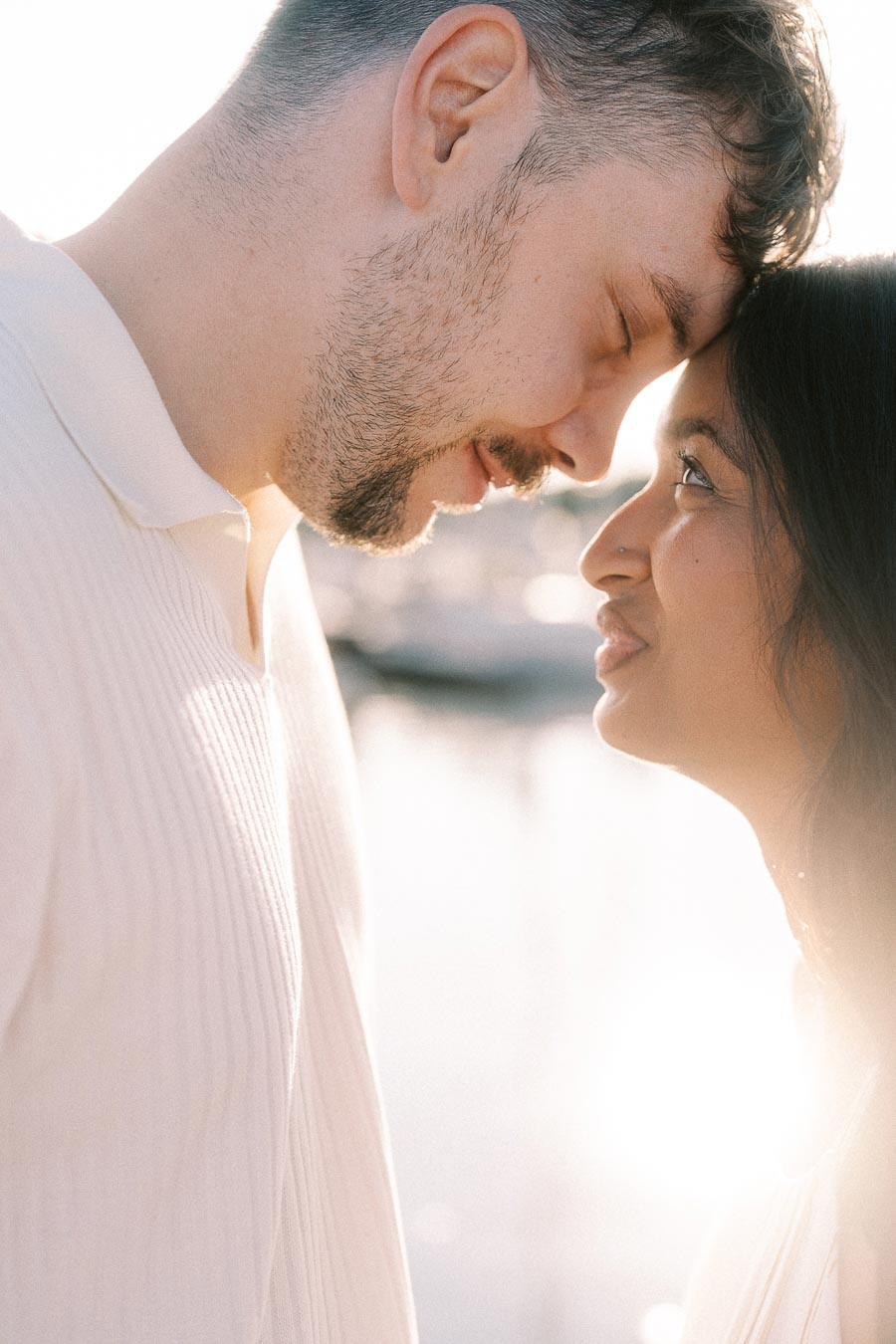 Amber and Devin share a close-up golden hour moment by the marina in Hamilton, Ontario.