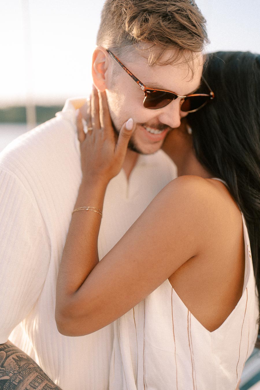 Amber and Devin share a close embrace during their golden hour engagement session in Hamilton.