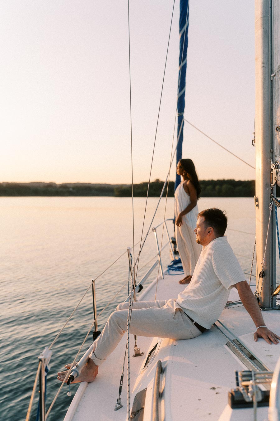 Amber and Devin relaxing on a sailboat at sunset on Lake Ontario in Hamilton.