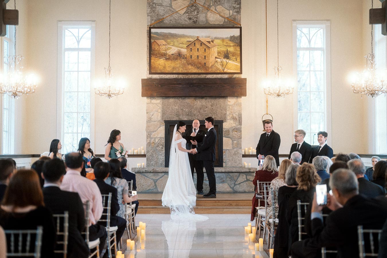 Couple exchanging vows during an indoor wedding ceremony with seated guests