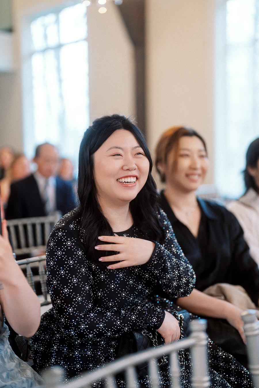 Smiling guest seated indoors during an engagement celebration or ceremony