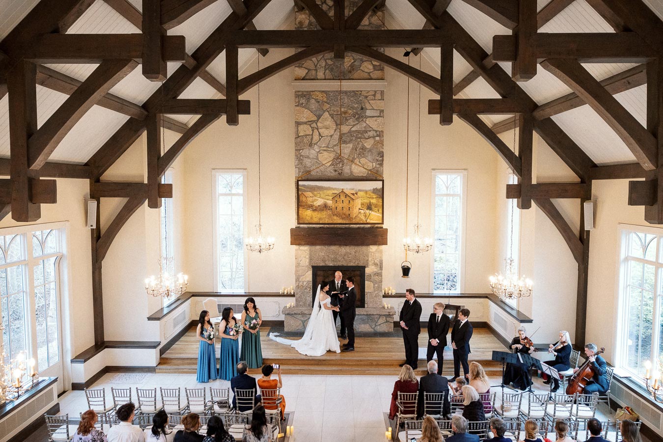 Couple exchanging vows during an indoor wedding ceremony in a timber-framed chapel