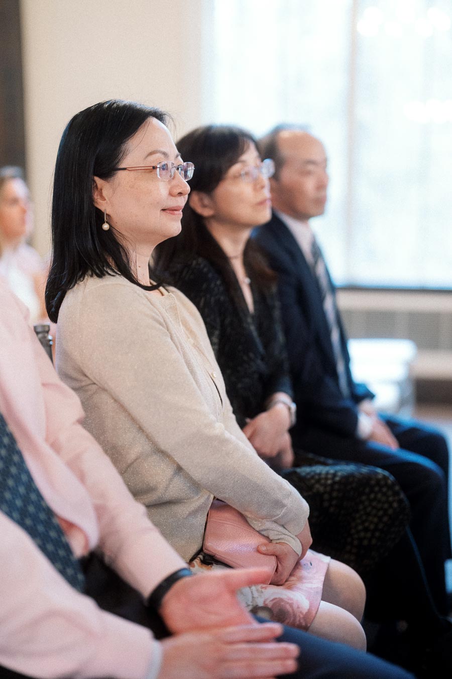 Seated guests attentively watching during an indoor engagement photoshoot event