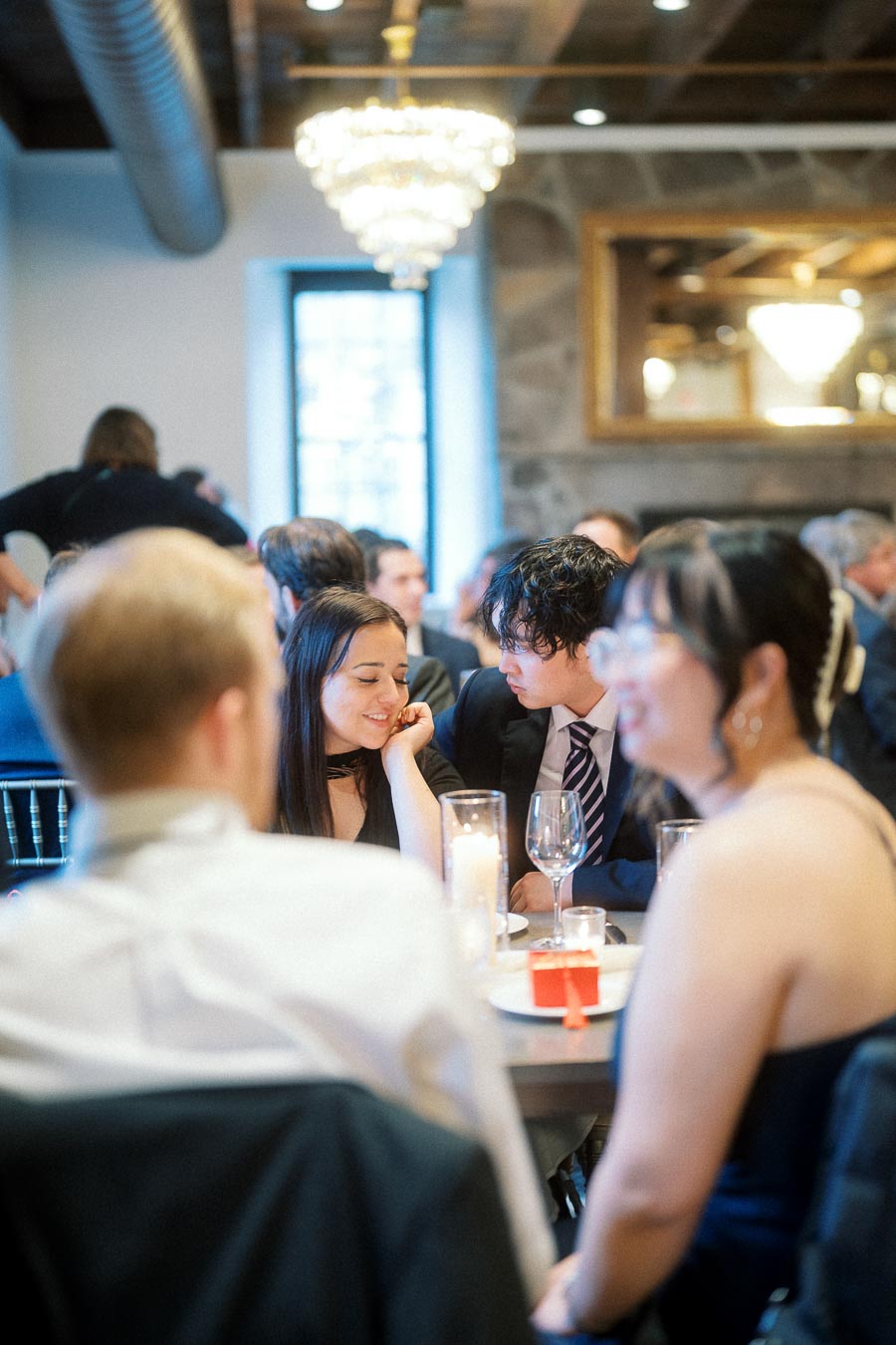 Couple sharing a quiet smile at a formal indoor dinner table