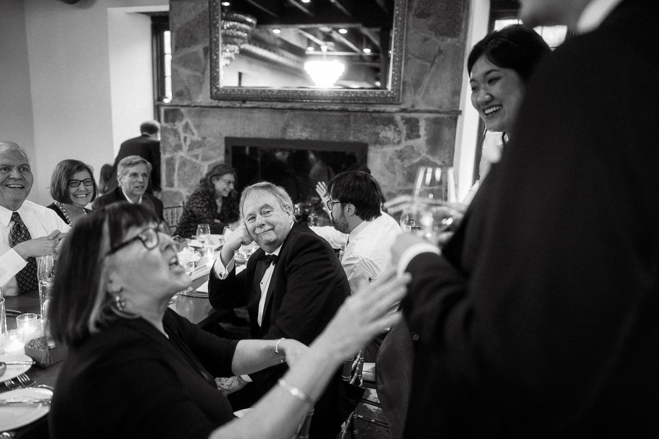 Guests smiling and talking during a formal dinner reception