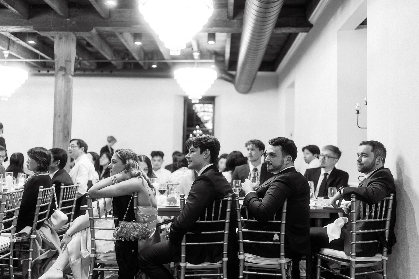 Guests seated at banquet tables during a formal indoor event
