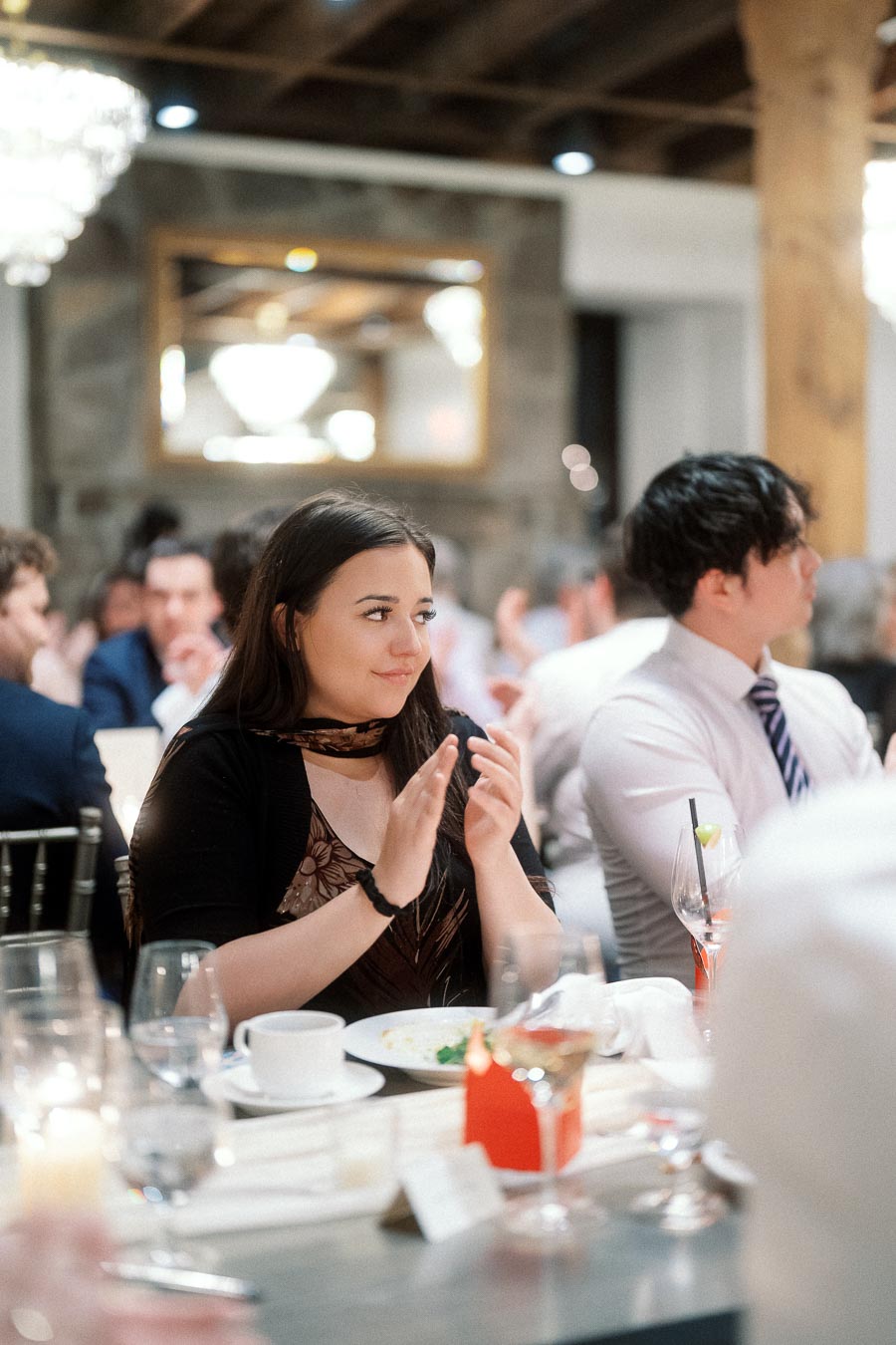 Woman applauding at a reception table during an engagement celebration