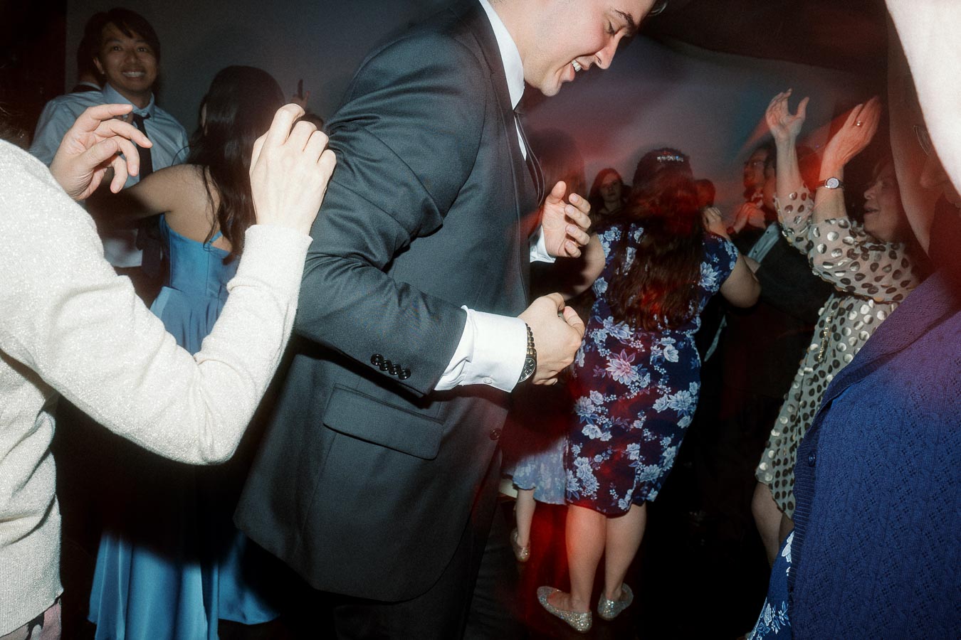 Guests dancing together on a crowded indoor dance floor
