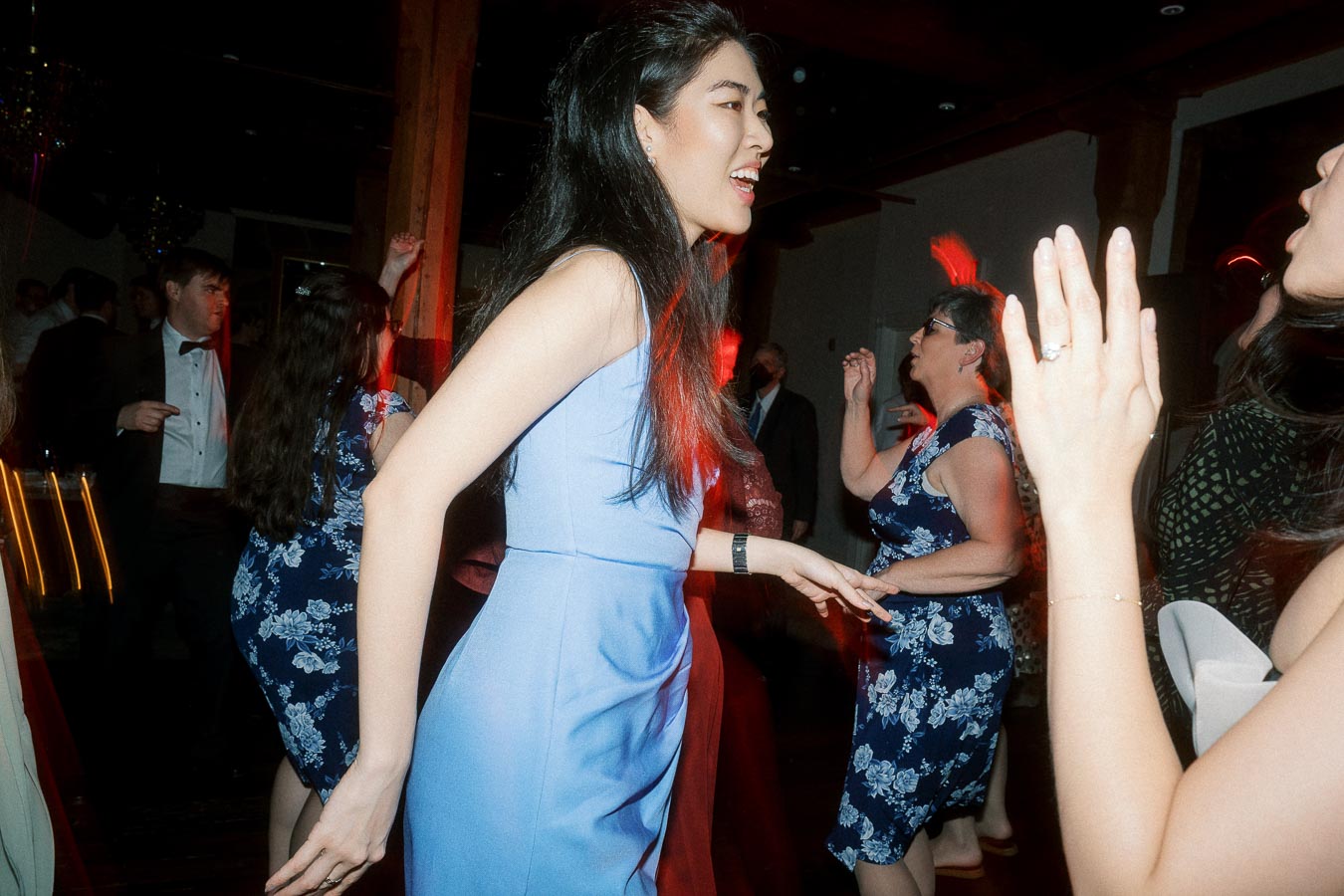 Guests dancing and laughing together at an indoor celebration