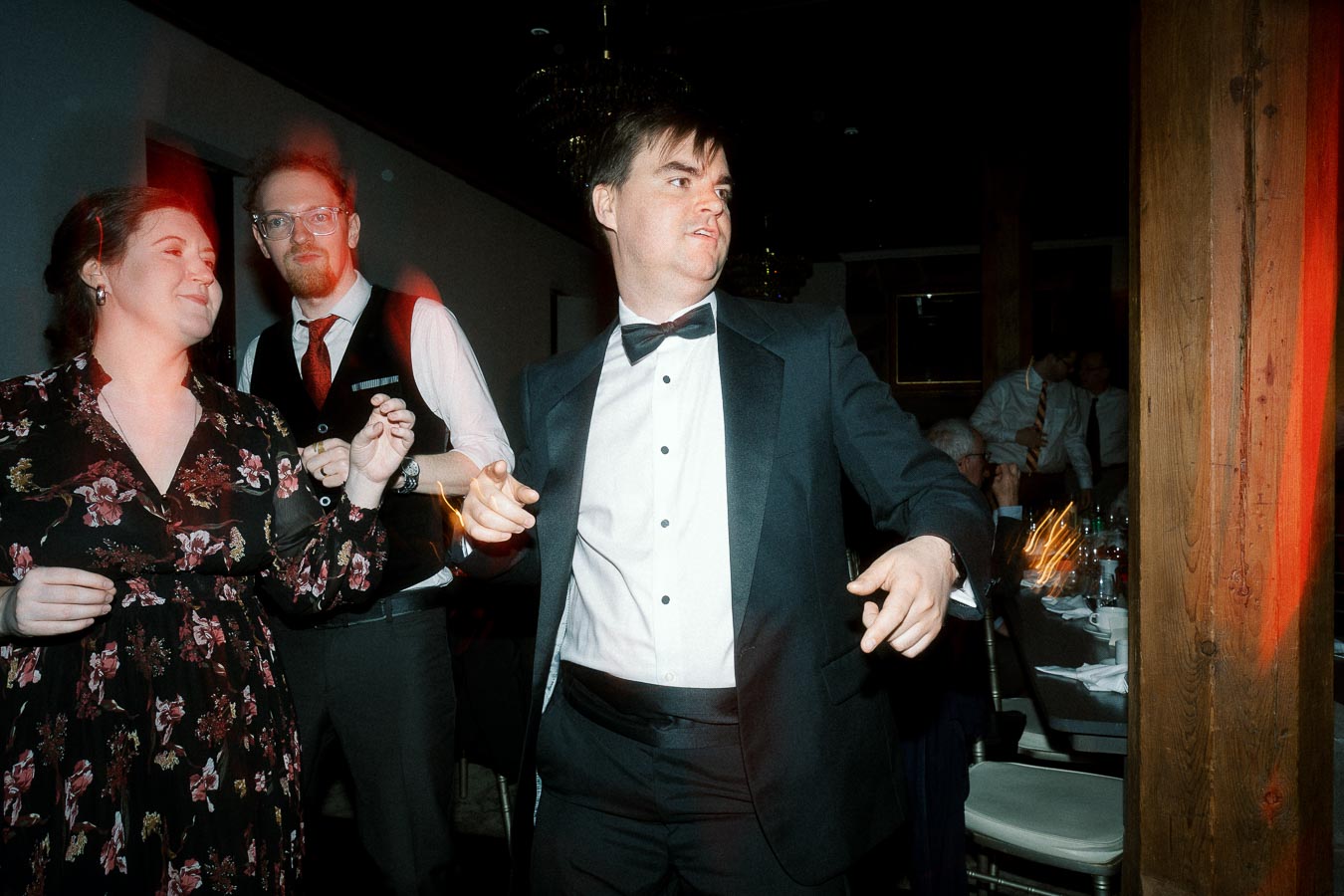 Guests in formal attire dancing together at an indoor reception