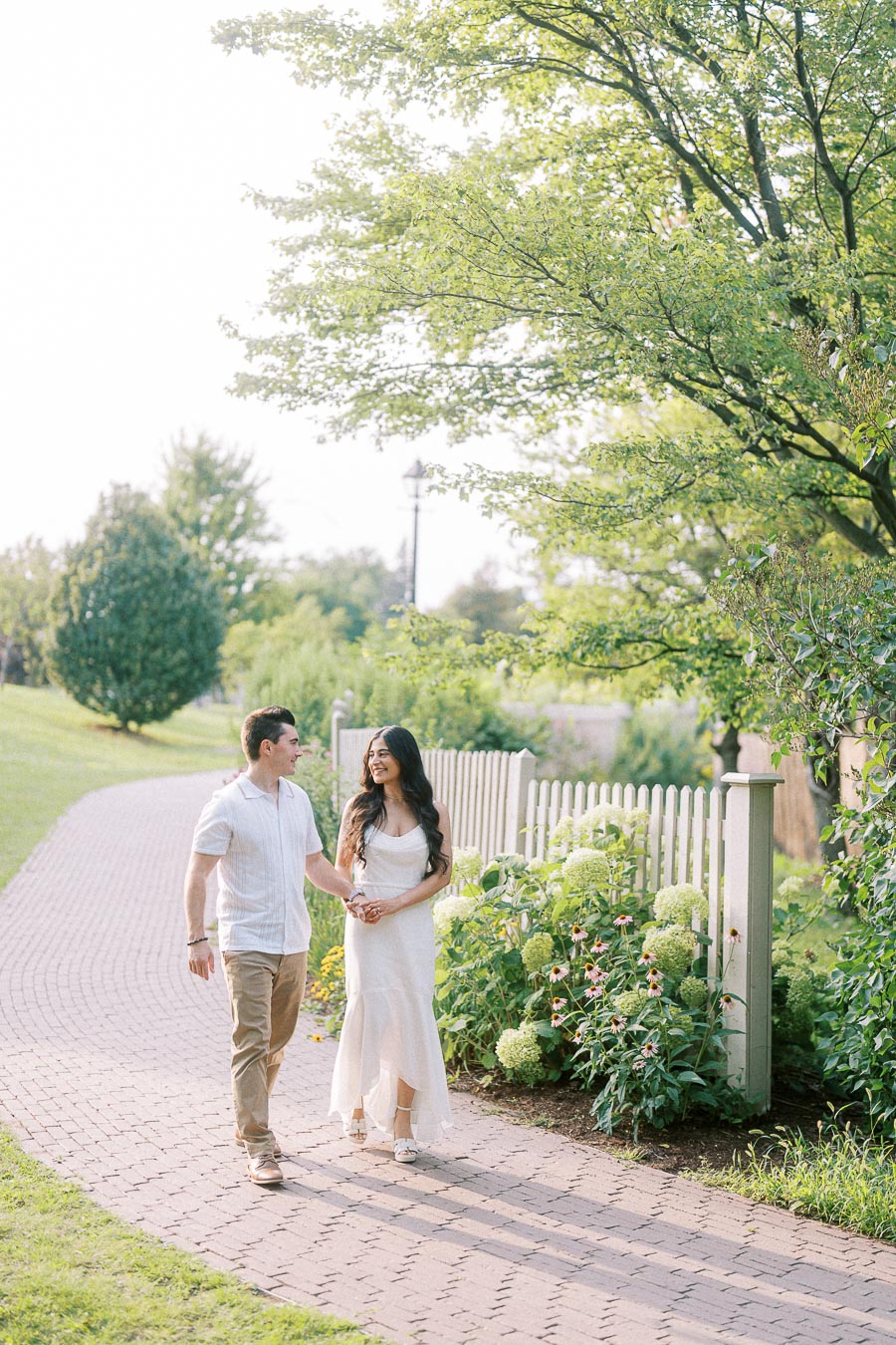 Sumbul and Brian walking through Dundurn Castle gardens in Hamilton