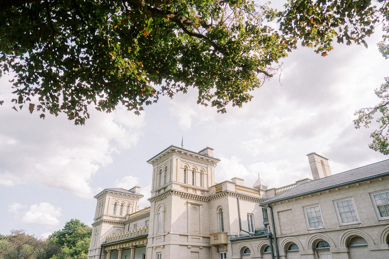 Dundurn Castle exterior towers framed by leafy trees in Hamilton