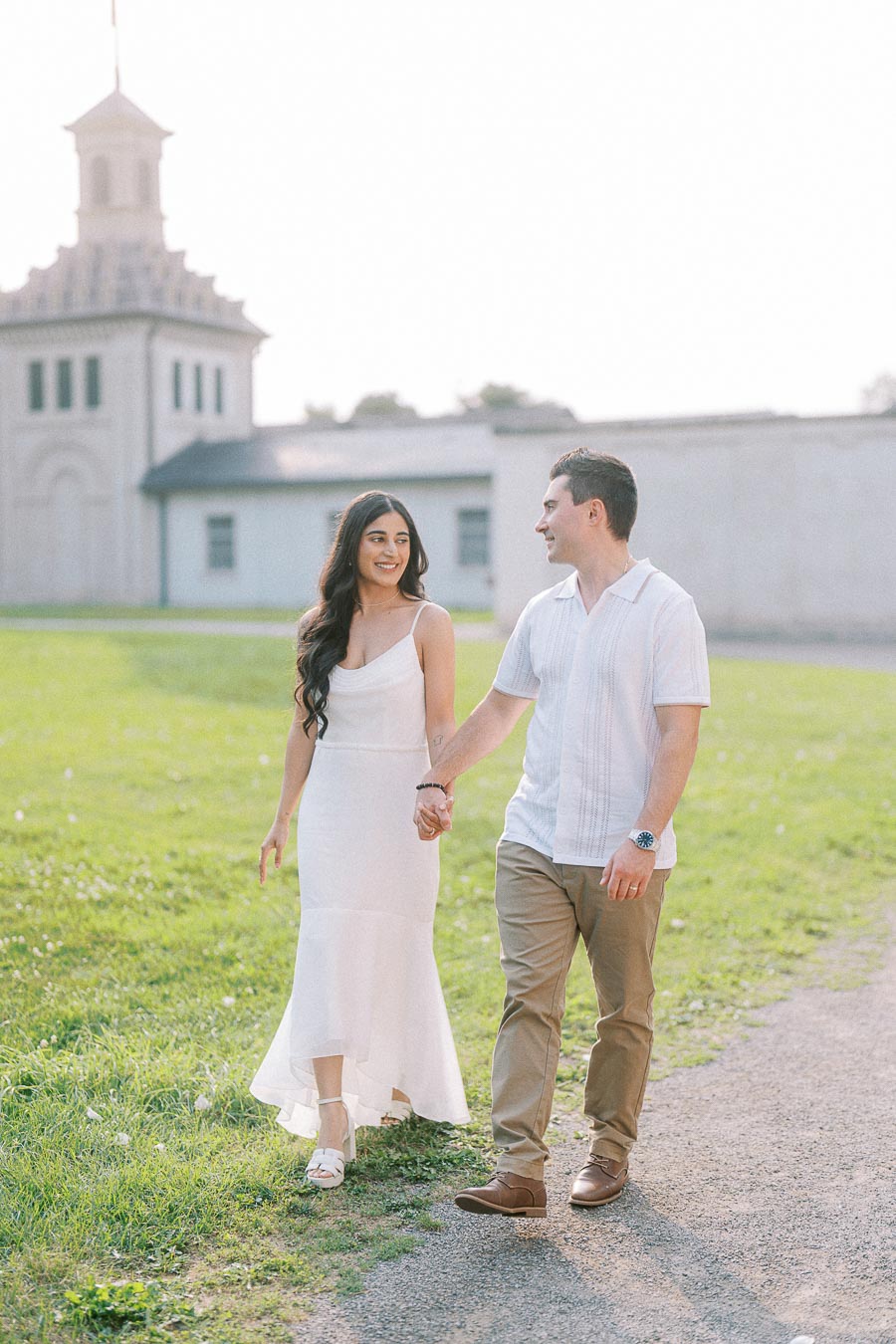 Sumbul and Brian walking hand in hand at Dundurn Castle in Hamilton