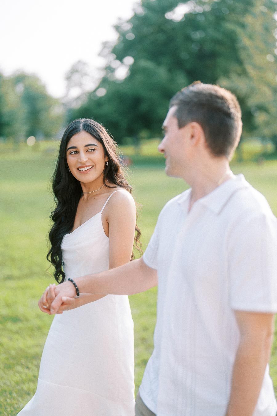 Sumbul and Brian holding hands during Dundurn Castle engagement photoshoot