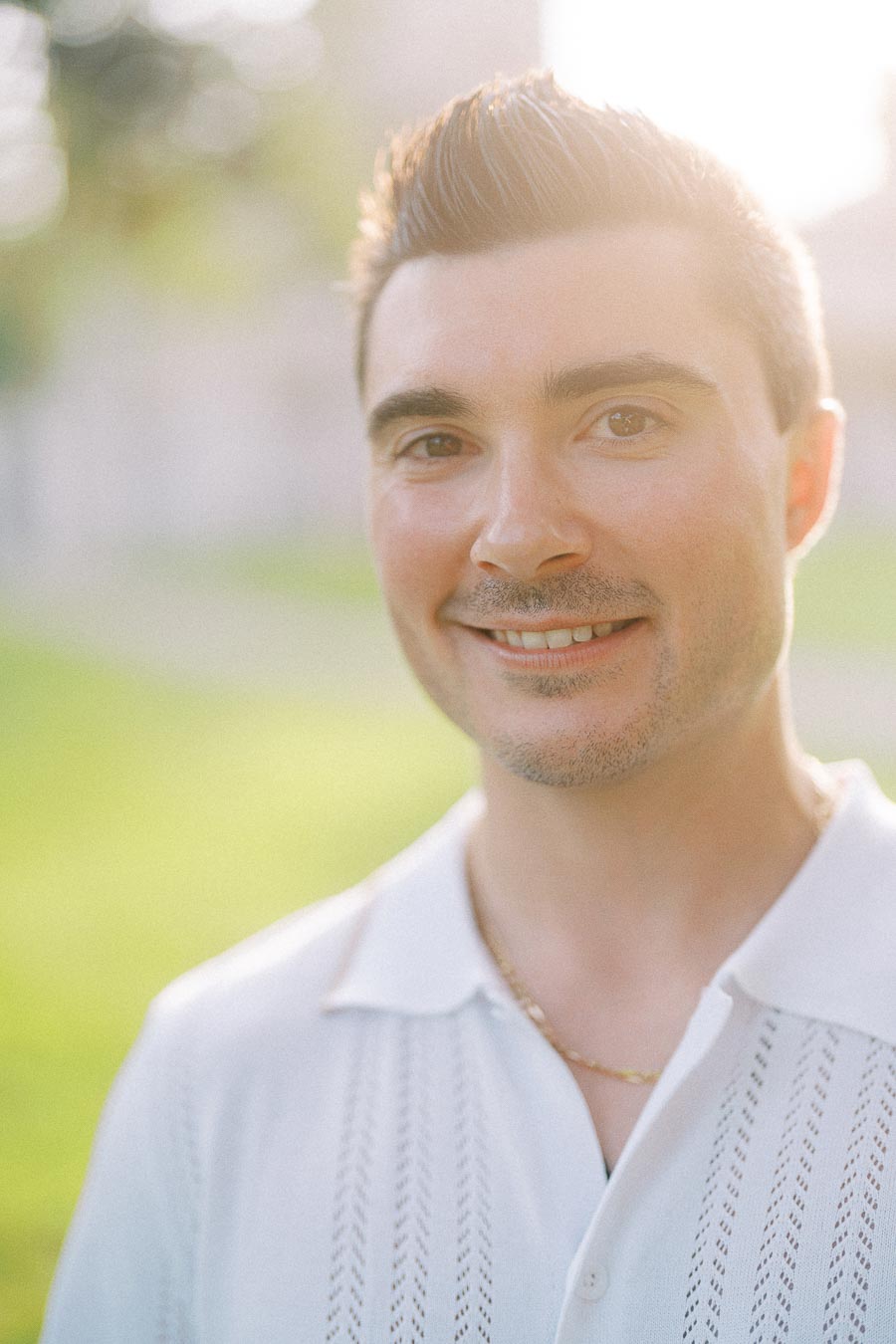 Brian smiling in a sunlit Dundurn Castle engagement portrait