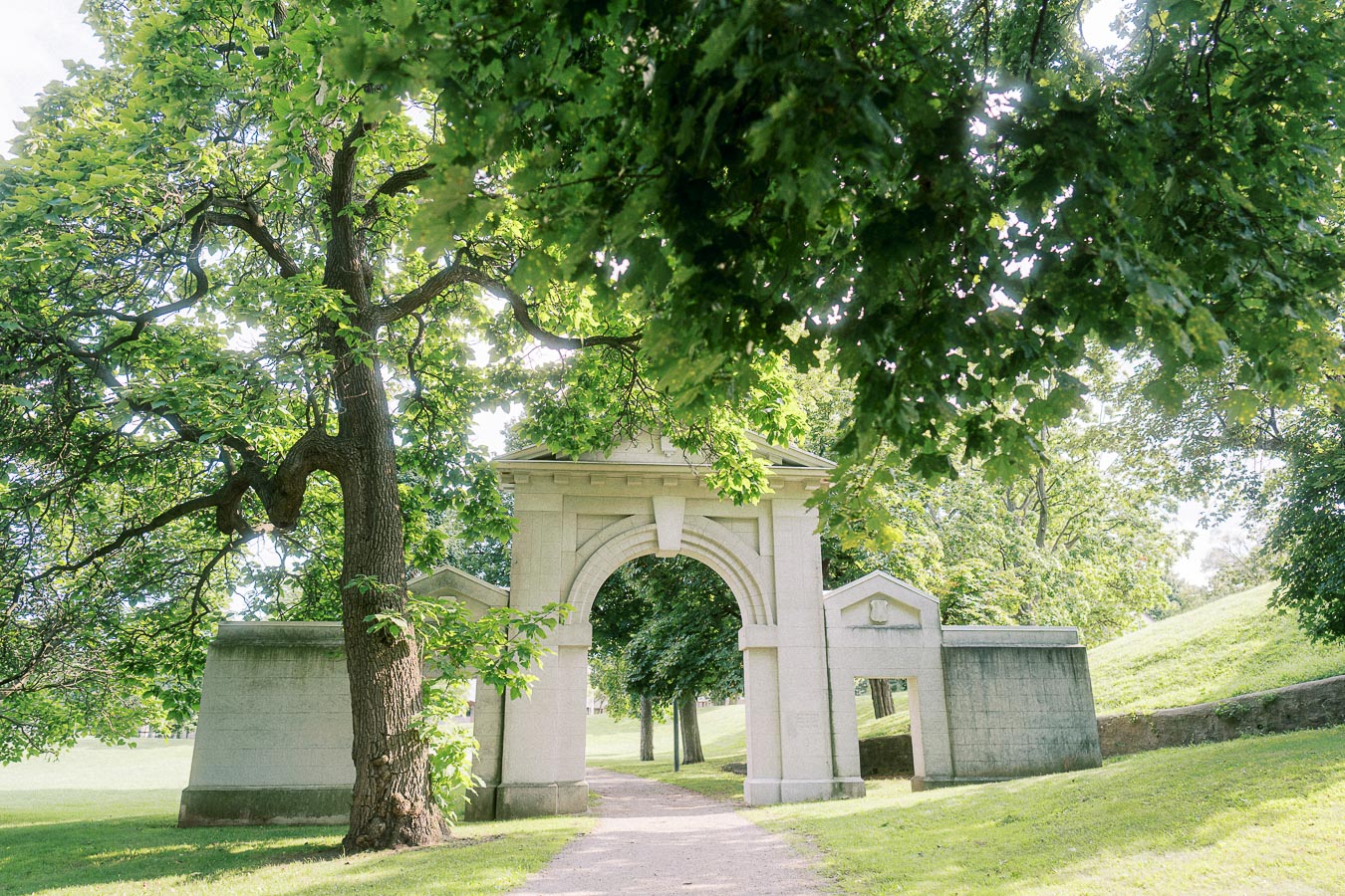 Stone archway and leafy trees at Dundurn Castle in Hamilton